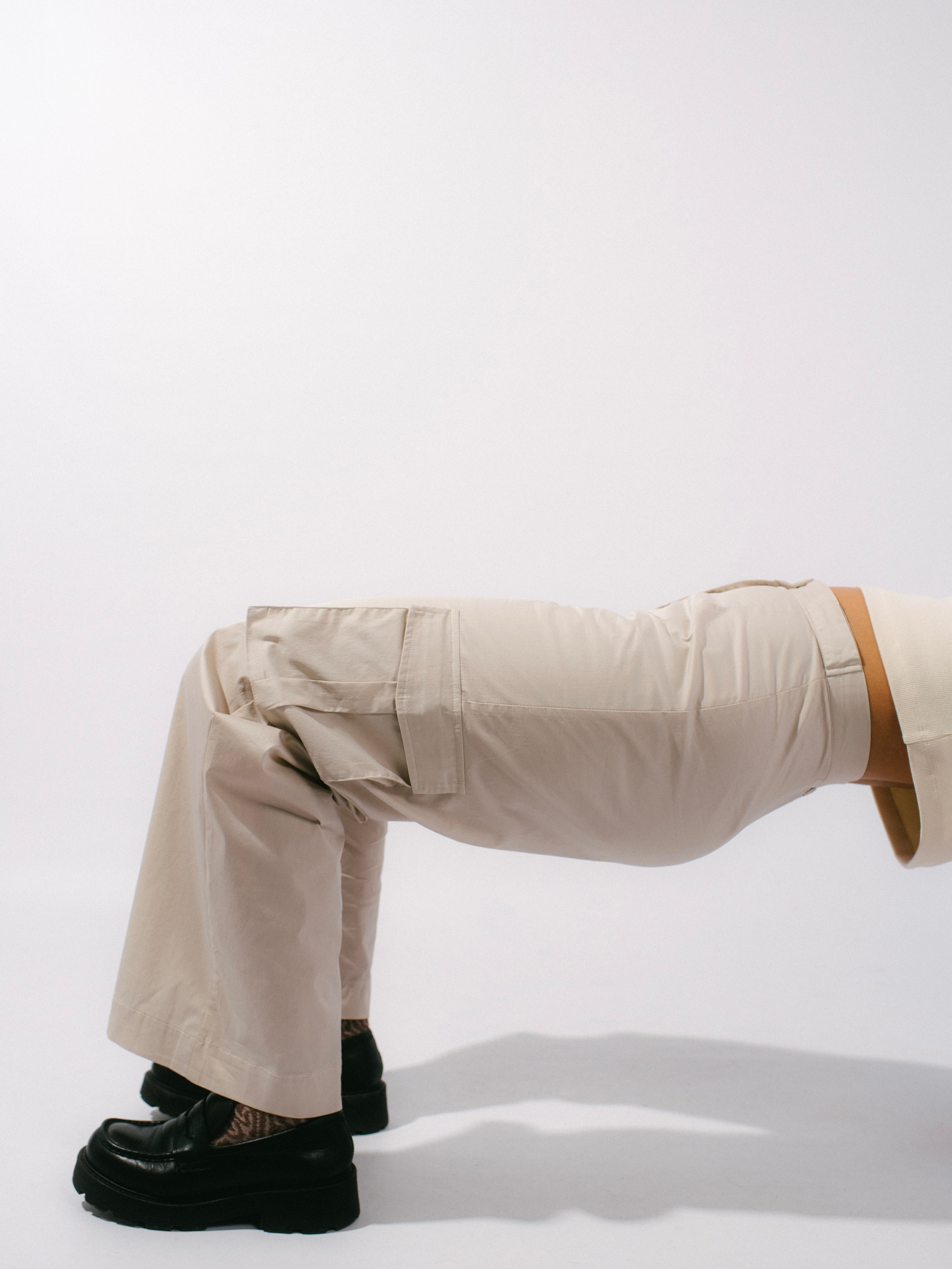 Side profile of cargo pants styled on model