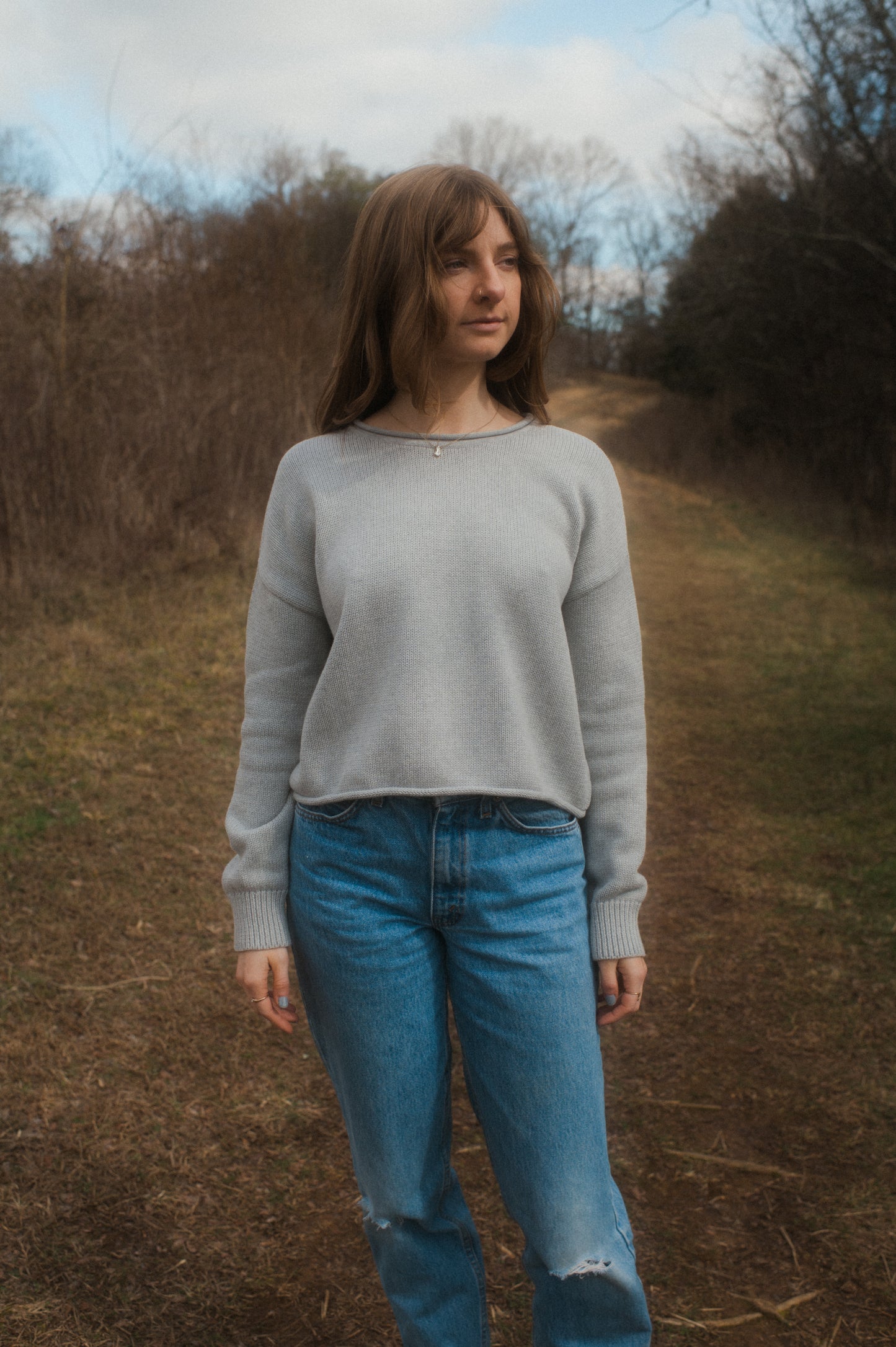 model standing in grey true knit cotton sweater.
