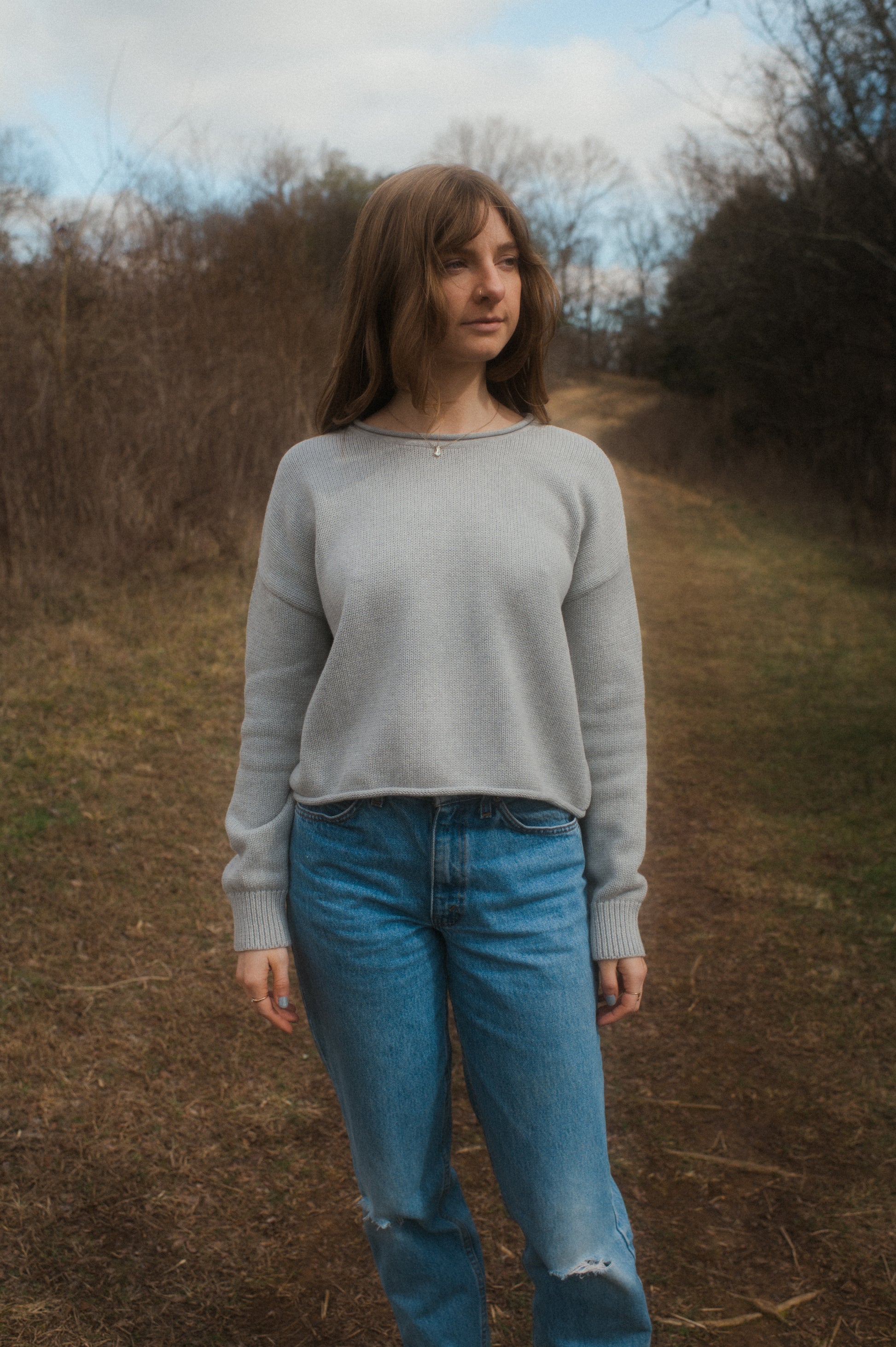 model standing in grey true knit cotton sweater.