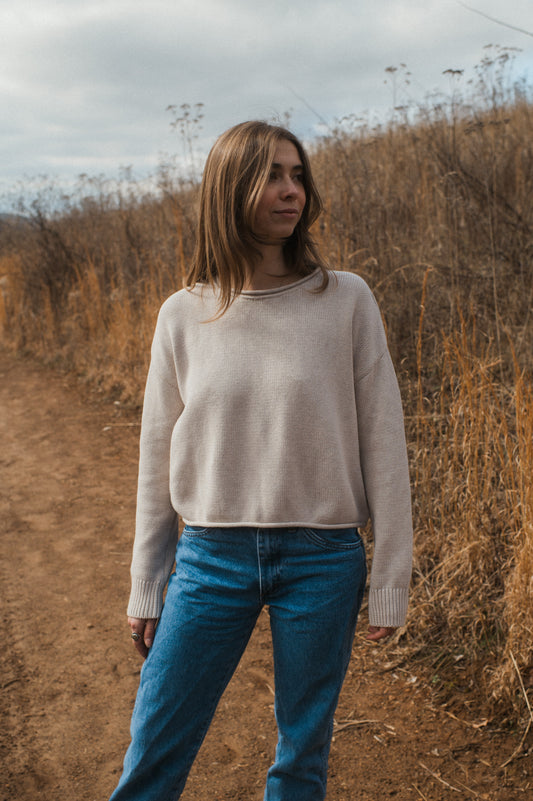 model standing in oat true knit cotton sweater.