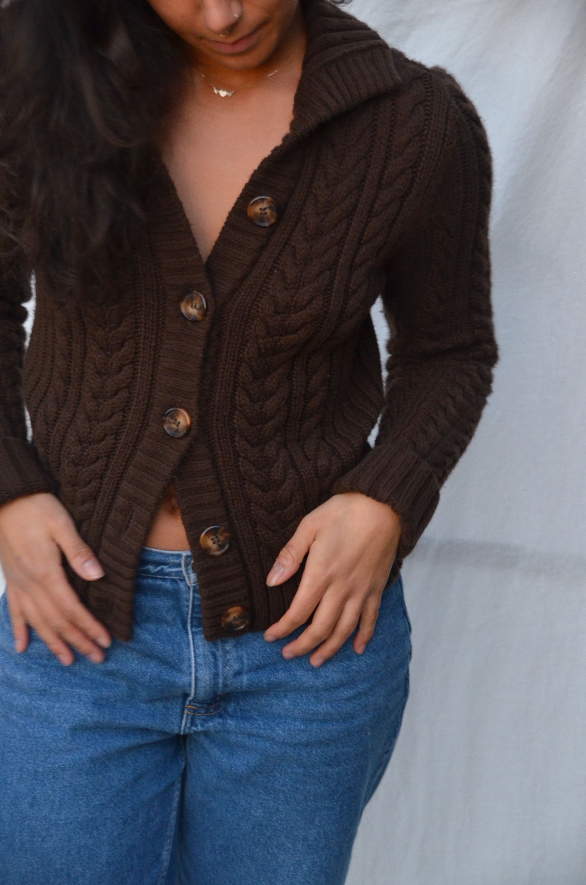 brown chunky cable knit sweater with buttons and a collar